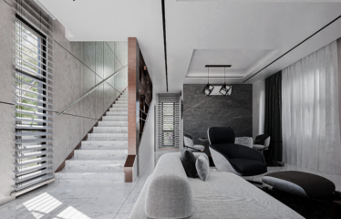 A 2 bedroom semi-detached townhouse for sale in Adenta Accra. An open plan living room white tones