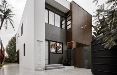 The back of a 3 bedroom house for sale at Regimanuel Satellite City Adenta in Accra from the back kitchen door onto a nicely tiled floor cordened off from the main garden.